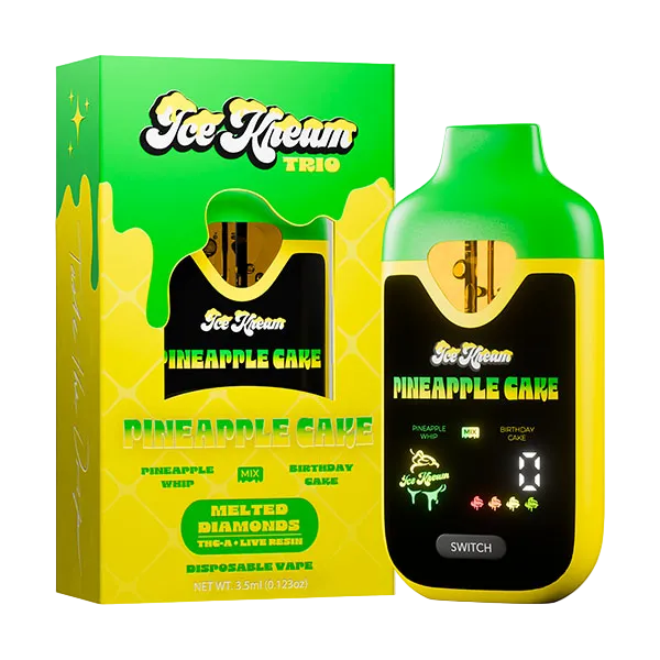Ice Kream Pineapple Cake disposable vape and its packaging box, featuring a bright green and yellow color scheme with a black screen panel on the device.